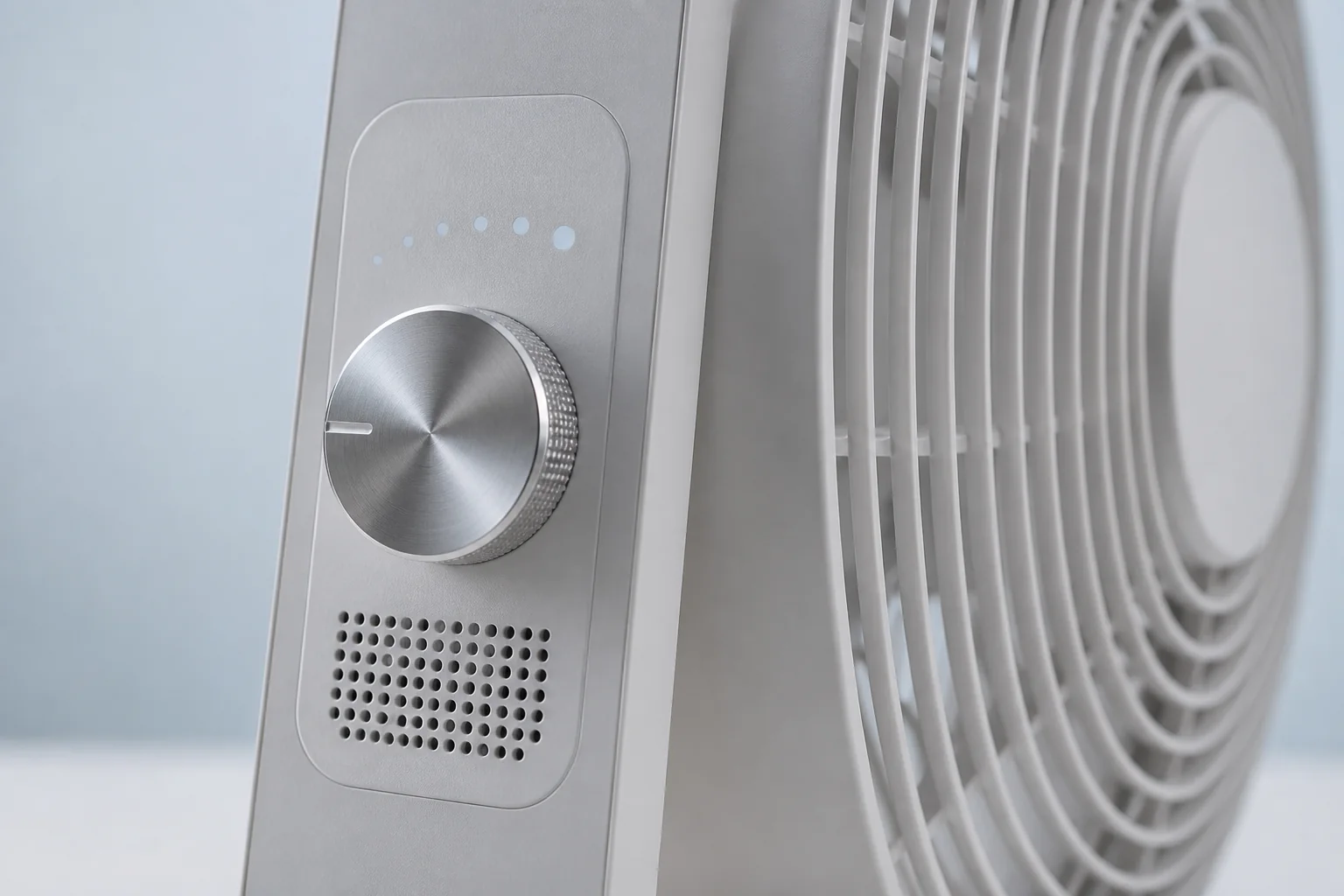 Close-up of the fan’s physical adjustment dial and sensor grille
